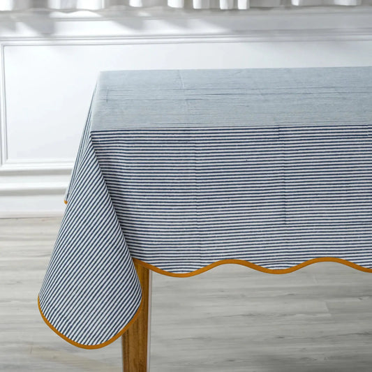 Tablecloth with blue and white striped pattern on a wooden table.