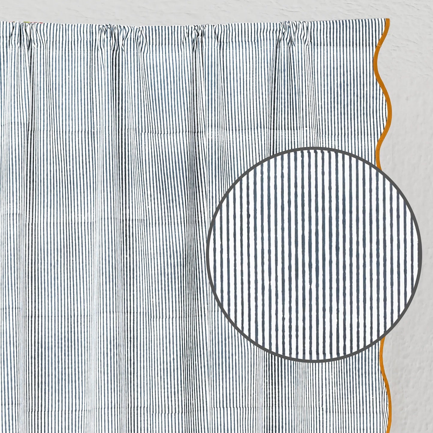 Textured fabric with a circular cutout and orange thread on a light gray background