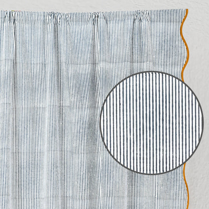 Textured fabric with a circular cutout and orange thread on a light gray background