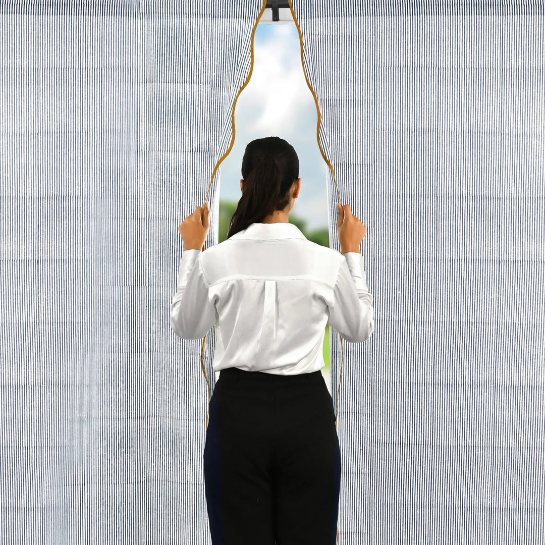 Person holding a unique mirror with a geometric design against a textured wall.