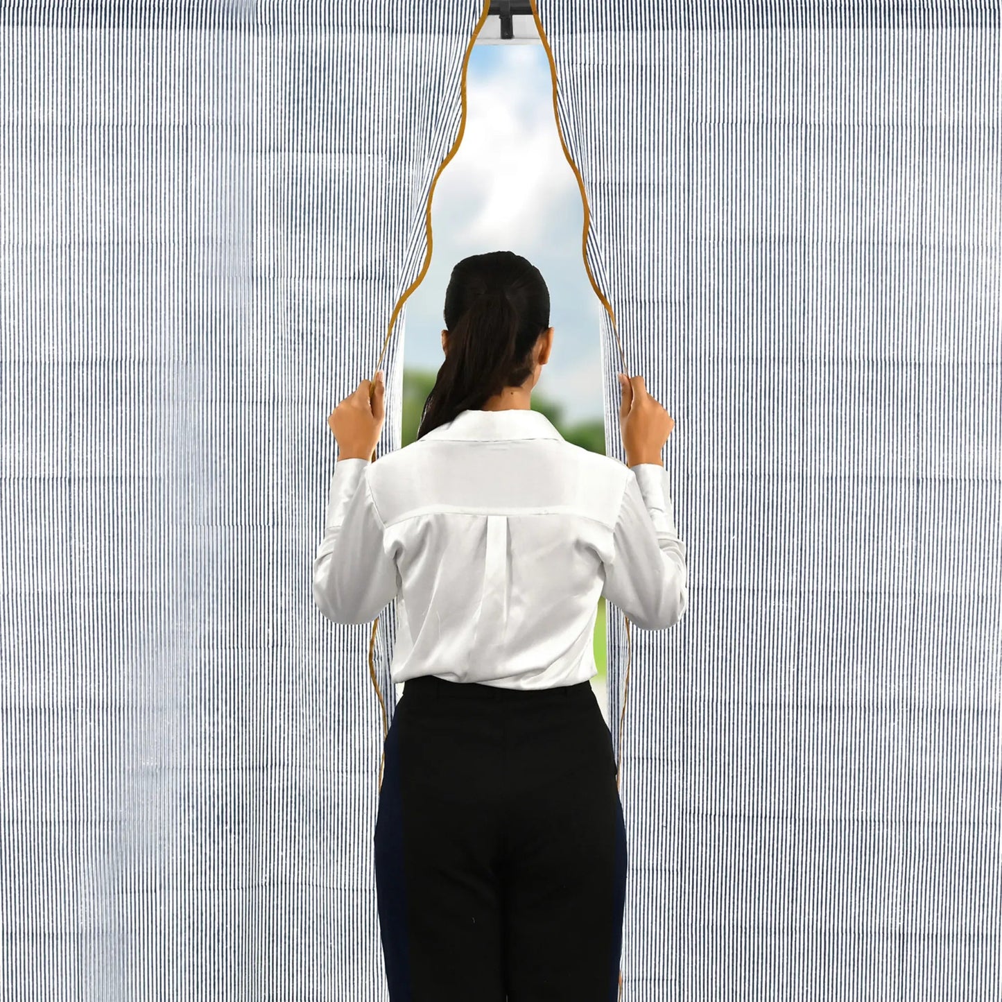 Person holding a unique mirror with a geometric design against a textured wall.