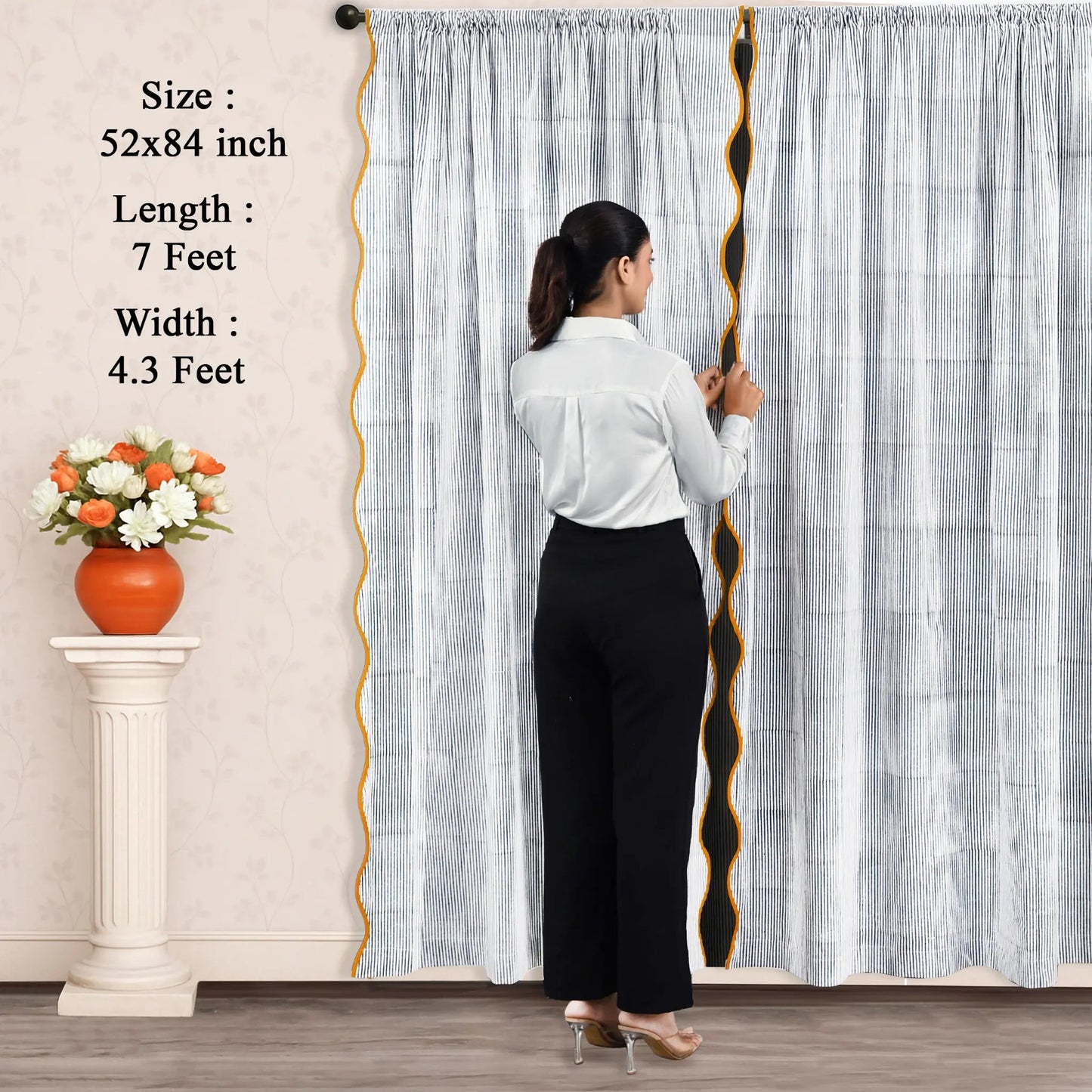 Woman standing in front of a large curtain with measurements displayed
