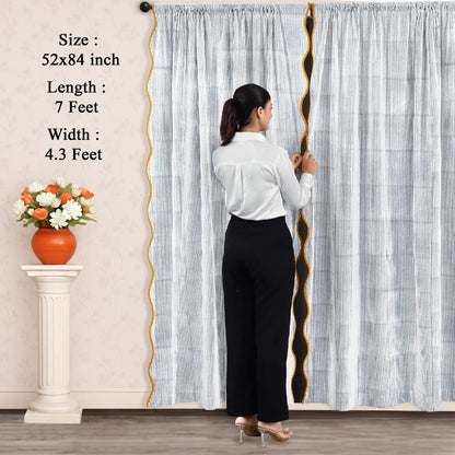 Woman standing in front of a large curtain with measurements displayed