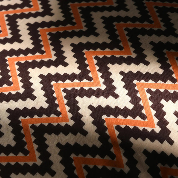 Patterned fabric with black, white, and orange design
