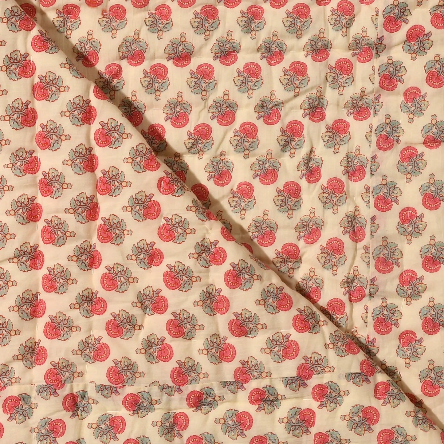 Fabric with a red and green pattern on a beige background
