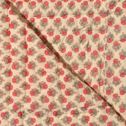 Fabric with a red and green pattern on a beige background