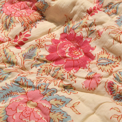 Floral patterned fabric with pink and blue flowers on a beige background