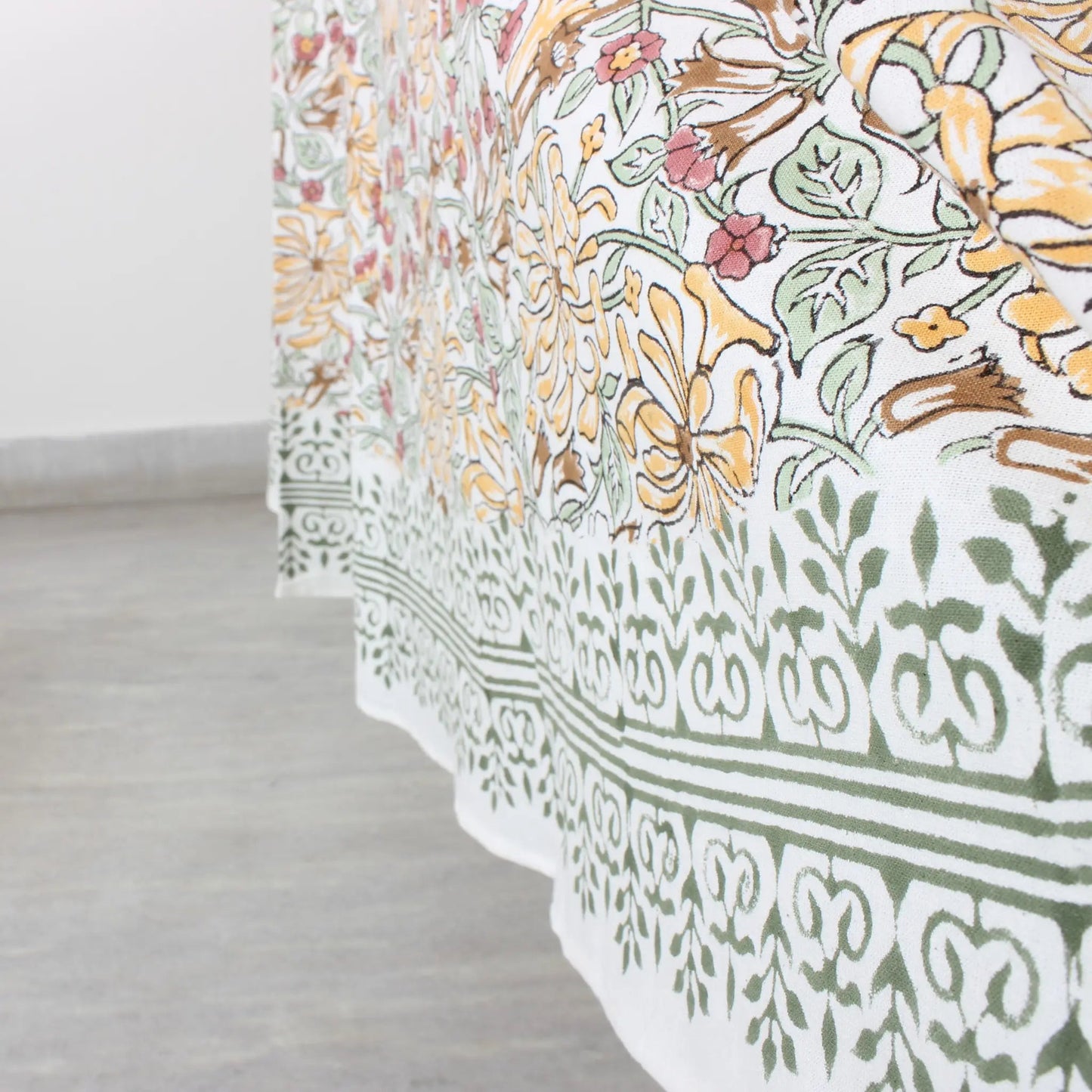 Floral and geometric patterned fabric on a light wooden floor