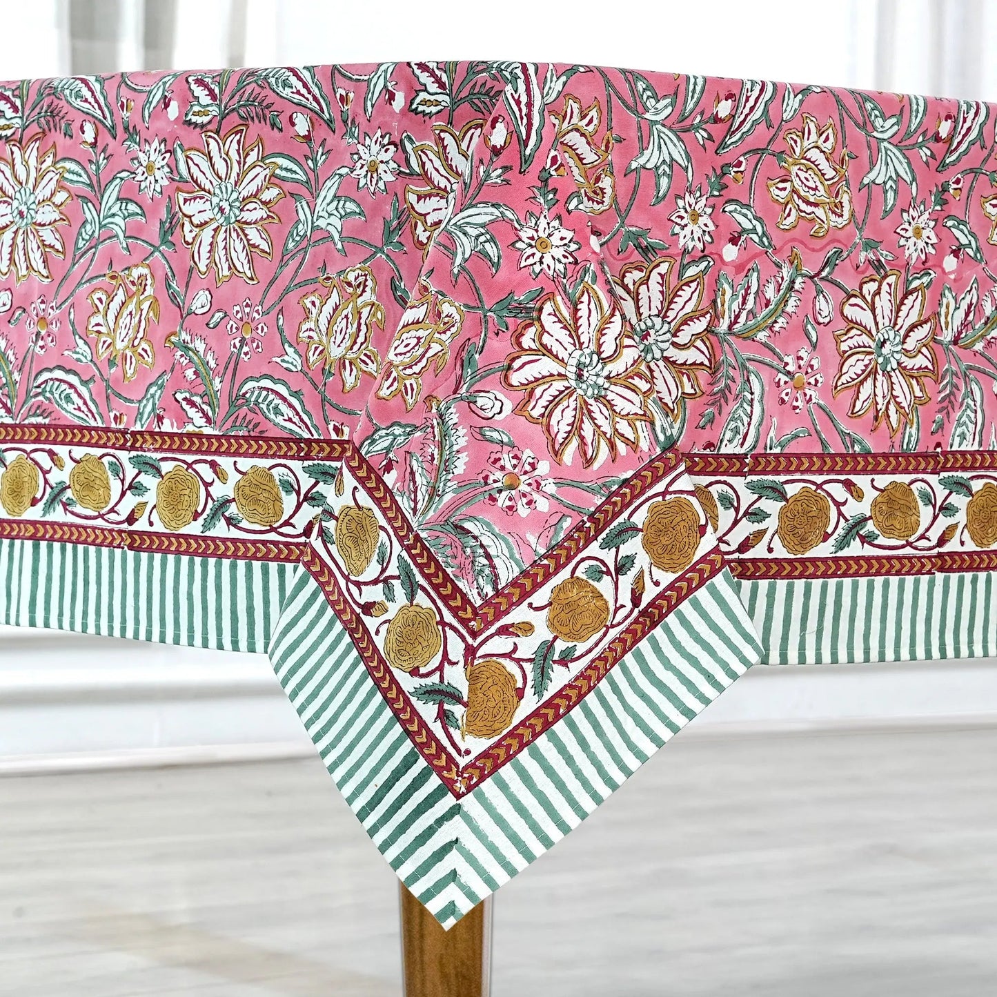 Floral and striped tablecloth on a wooden table