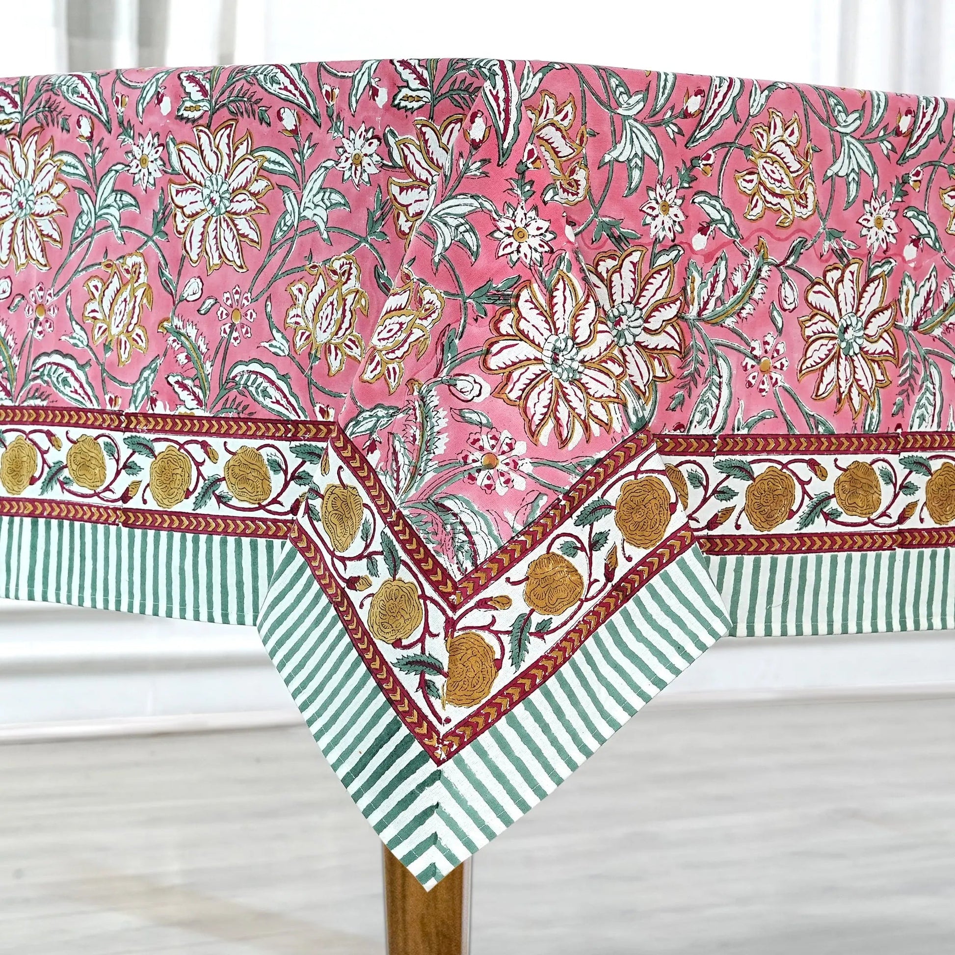 Floral and striped tablecloth on a wooden table