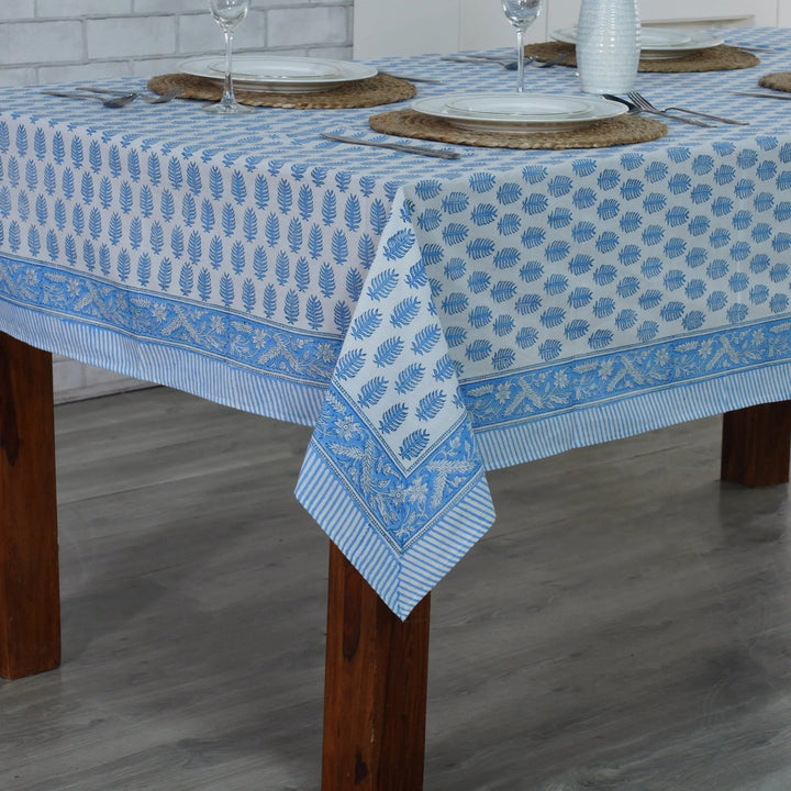 Tablecloth with blue floral pattern on a wooden table