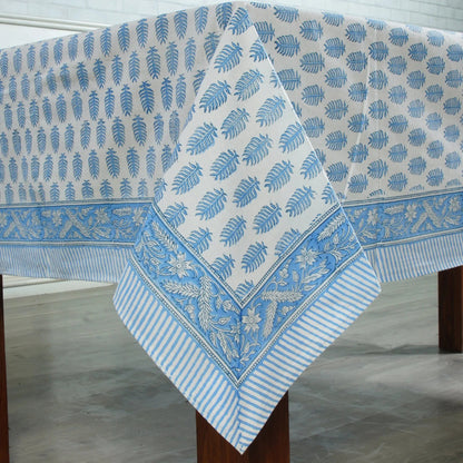 Blue and white patterned tablecloth on a wooden table