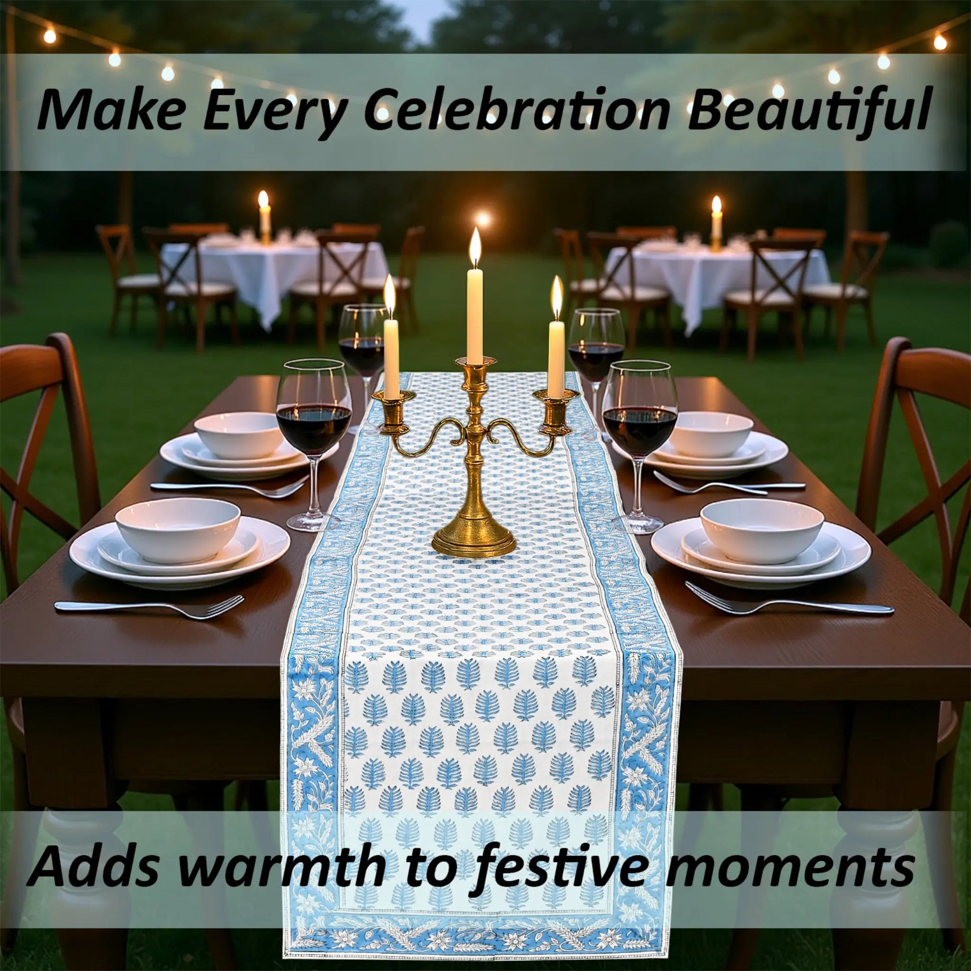 Dining table set for a celebration with a decorative table runner, candles, and wine glasses.