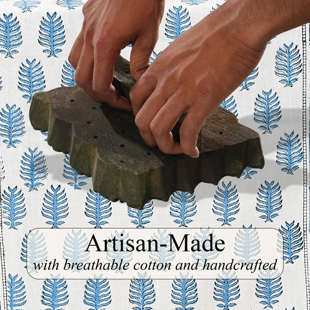 Hands working with a wooden tool on a patterned background with &