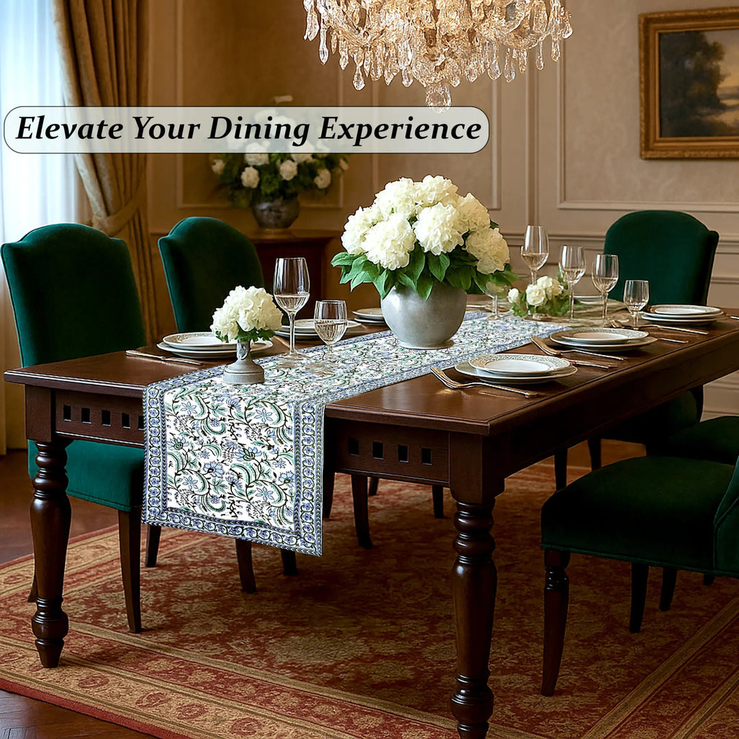 Dining room with a table set for dinner, flowers, and a chandelier.