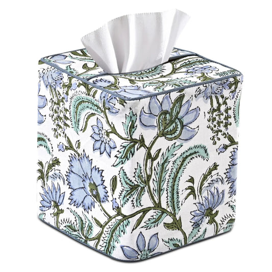 Floral-patterned tissue box cover with white tissues on a white background