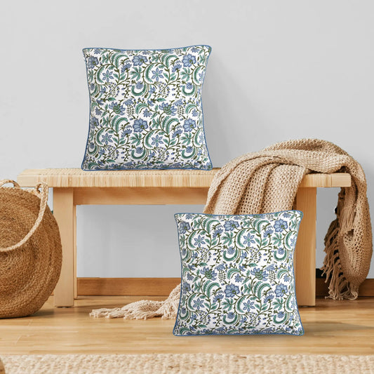 Floral patterned cushions on a wooden bench with a neutral background