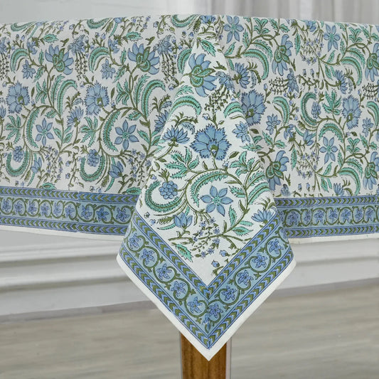 Floral patterned tablecloth on a wooden table with a neutral background