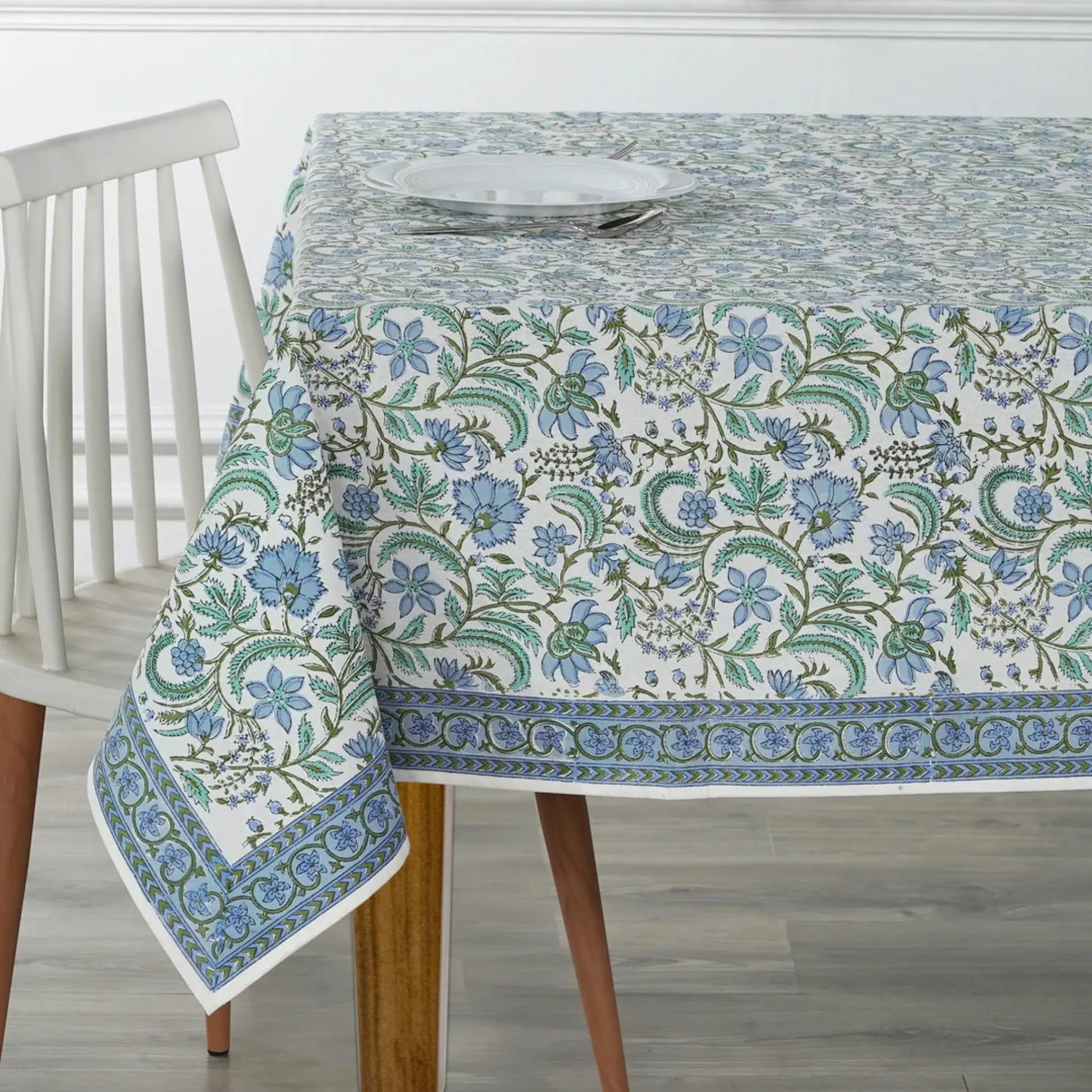 Tablecloth with floral pattern on a wooden table and chair