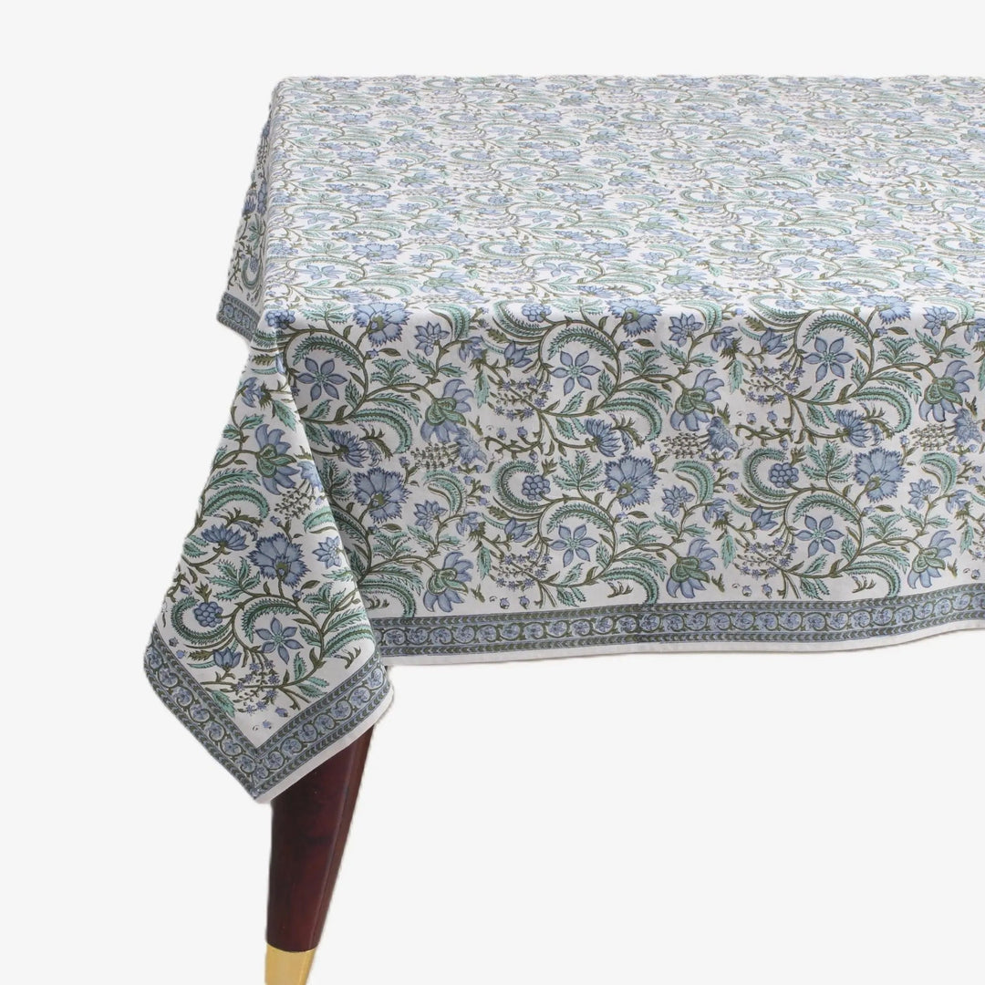 Floral patterned tablecloth on a table with a white background