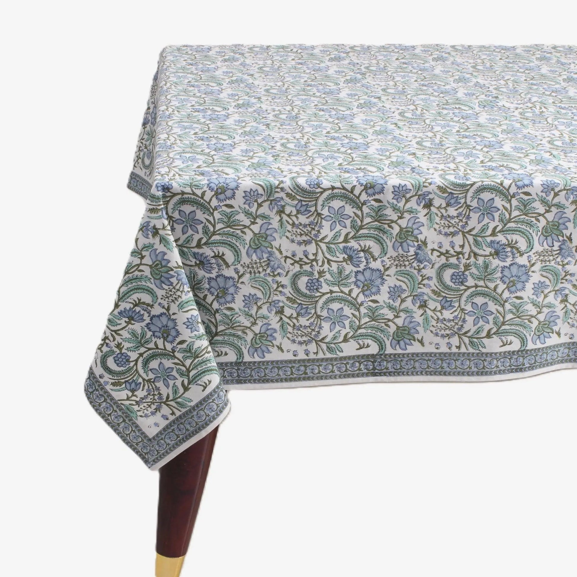 Floral patterned tablecloth on a table with a white background