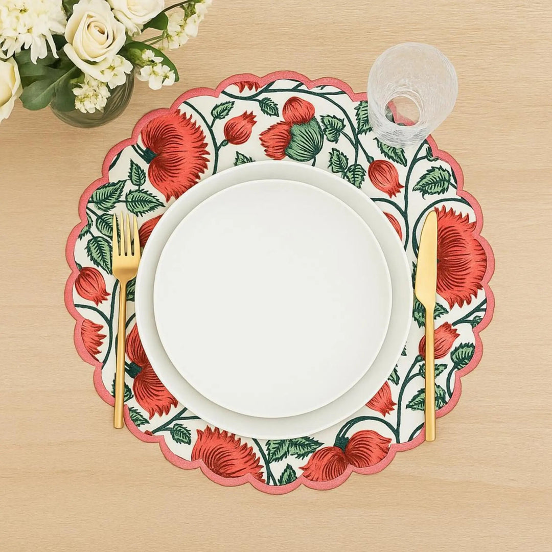 Floral placemat with red flowers on a wooden table