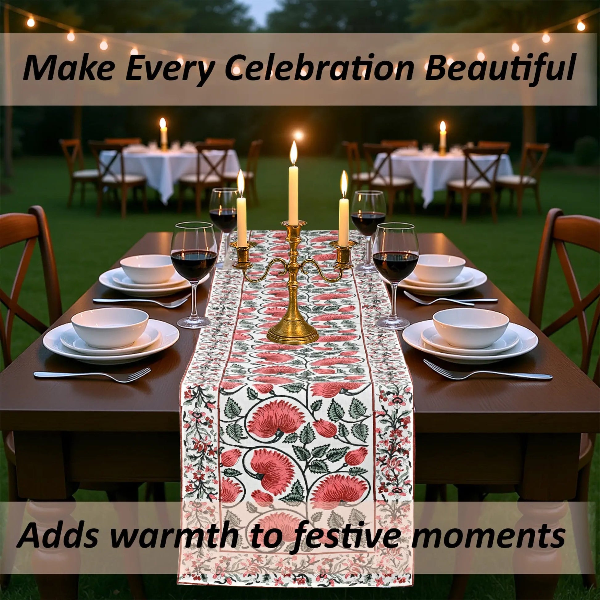 Dining table set with floral table runner, candles, and wine glasses outdoors.