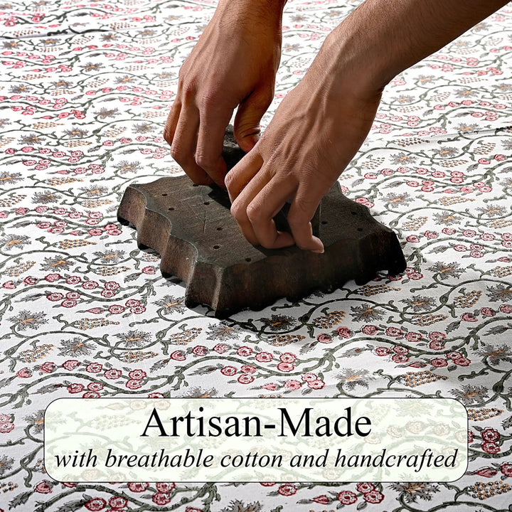 Hand using a stamp on fabric with &