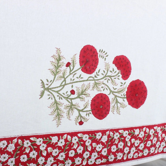 Embroidered tablecloth with red floral design on a white background
