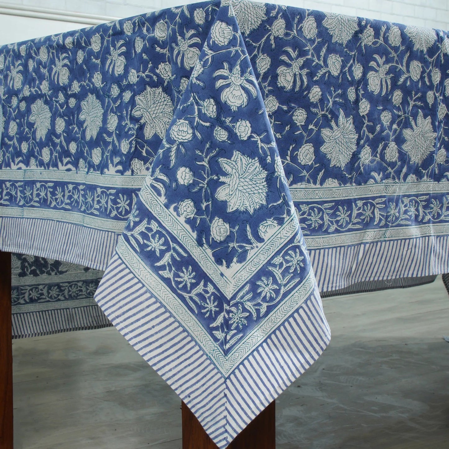 Blue floral patterned tablecloth on a wooden table