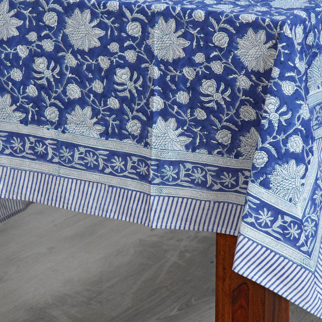 Blue floral patterned tablecloth on a wooden table