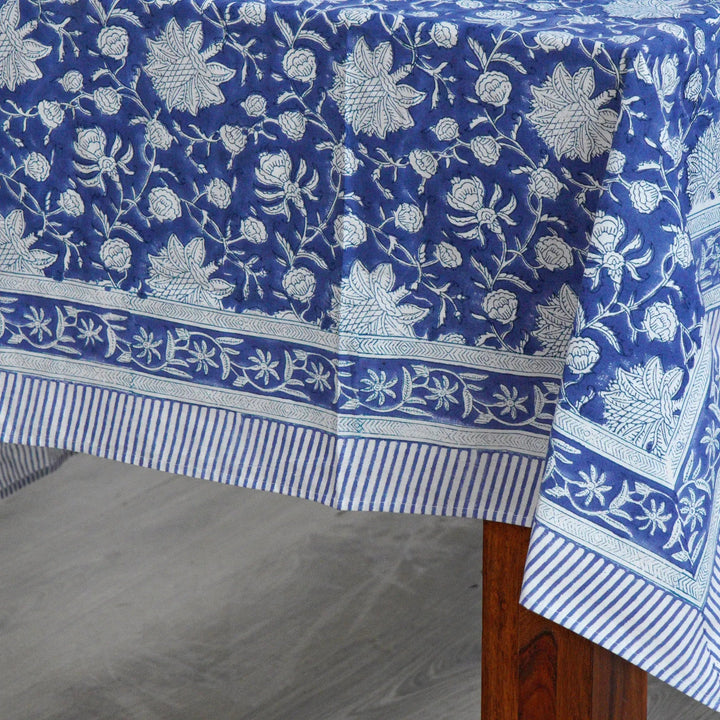 Blue floral patterned tablecloth on a wooden table