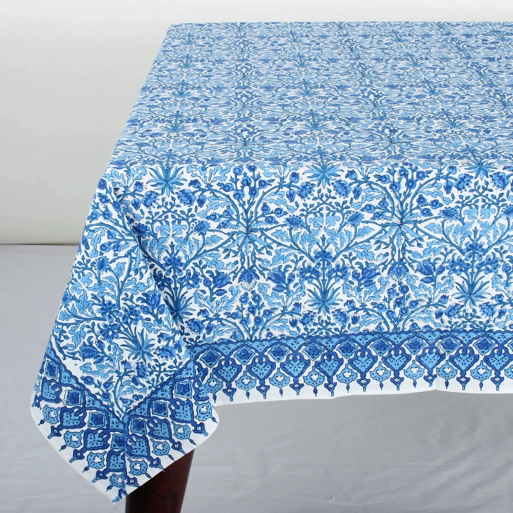 Blue floral patterned tablecloth on a gray surface