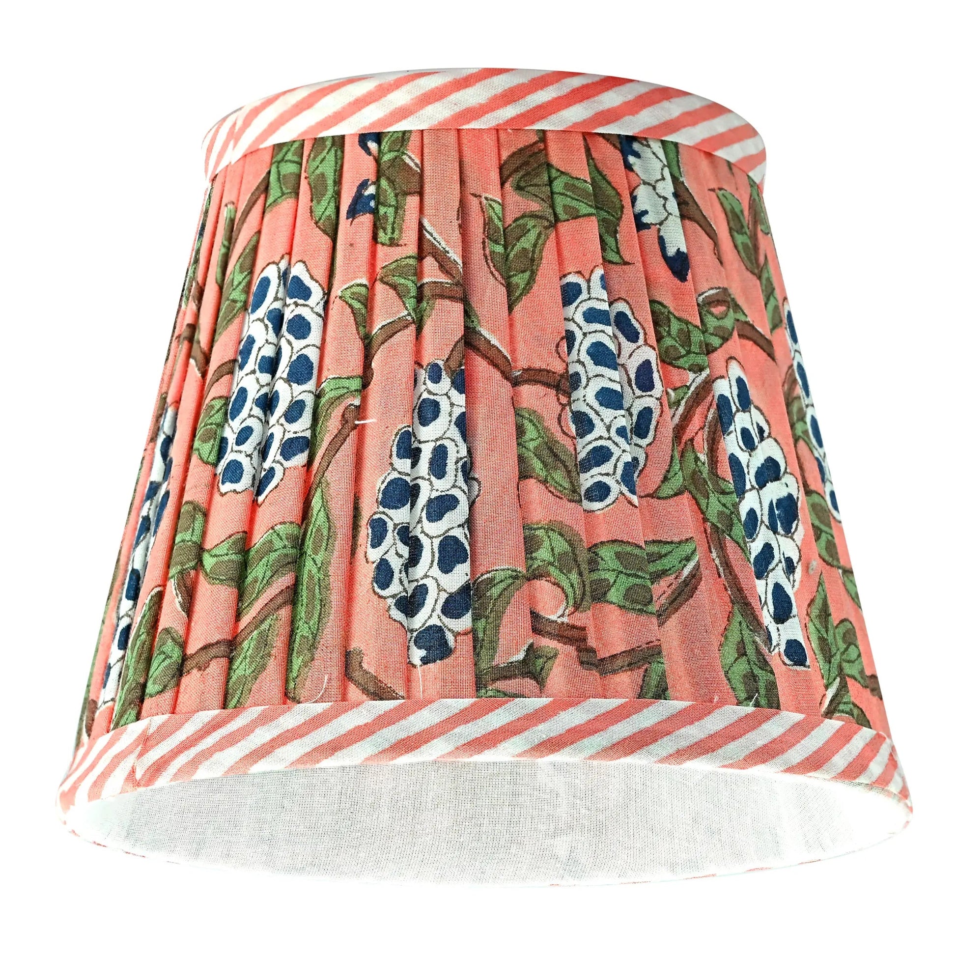 Floral patterned lampshade with striped base on a white background