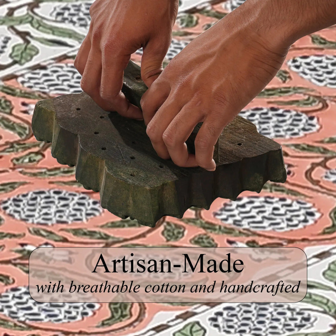 Hands using a traditional stamp on fabric with &