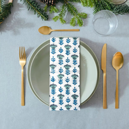 Napkin with floral pattern on a table setting with greenery