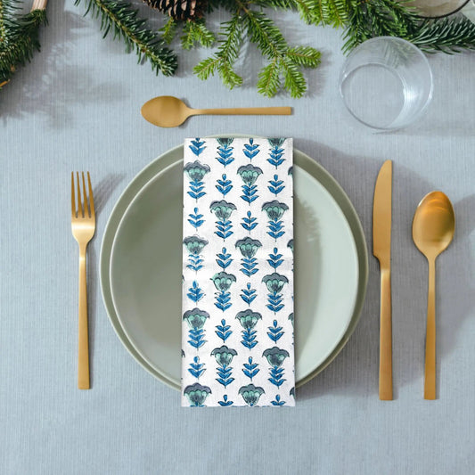 Napkin with floral pattern on a table setting with greenery
