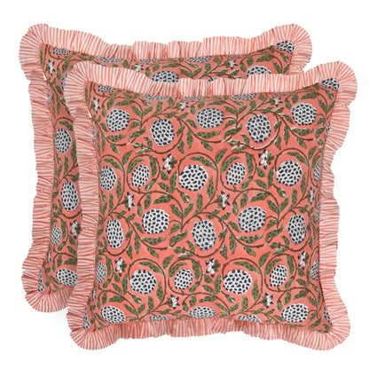 Decorative pillow with floral pattern and ruffled edge on a white background