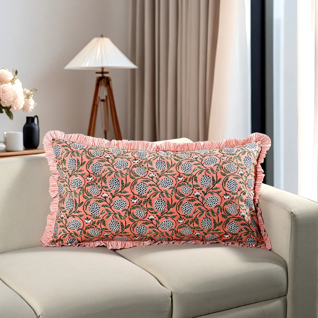 pink floral block print cotton pillow styled on a beige sofa in living room.