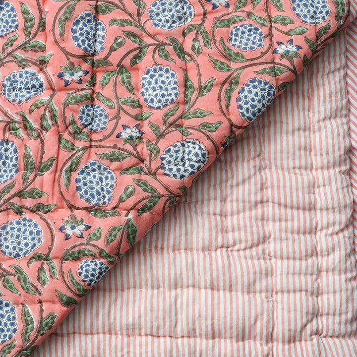 Quilt with floral pattern on a striped fabric background
