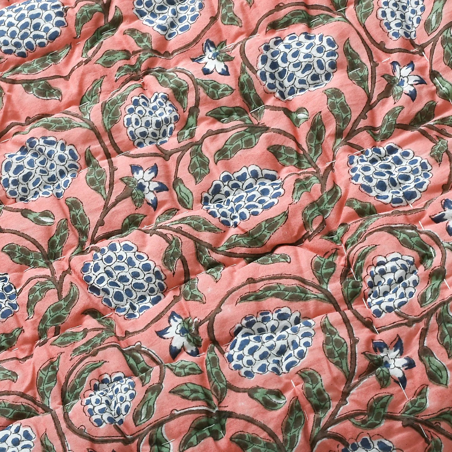 Floral pattern with blue flowers on a pink background