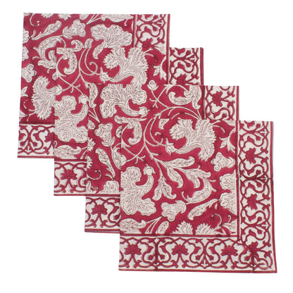Set of four red and white patterned napkins on a white background