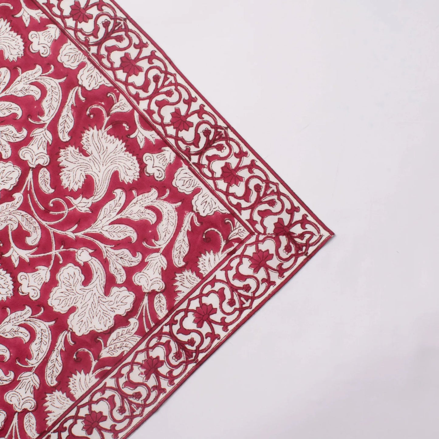 Red and white floral patterned fabric on a white background