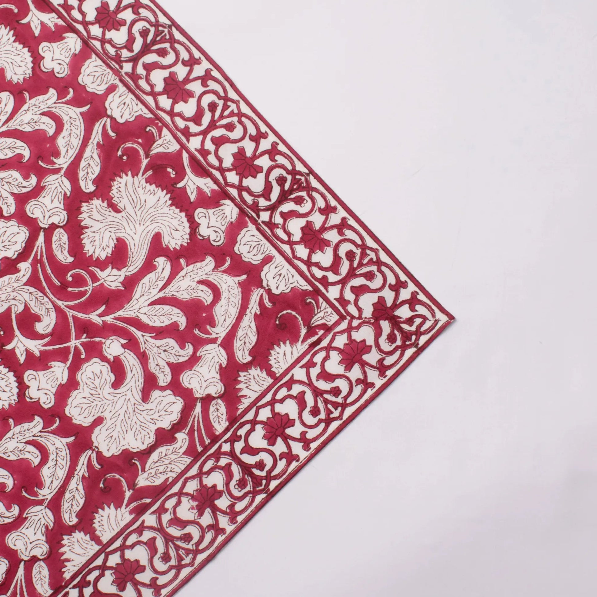 Red and white floral patterned fabric on a white background