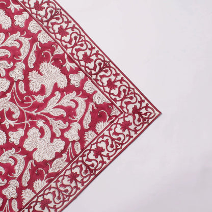 Red and white floral patterned fabric on a white background