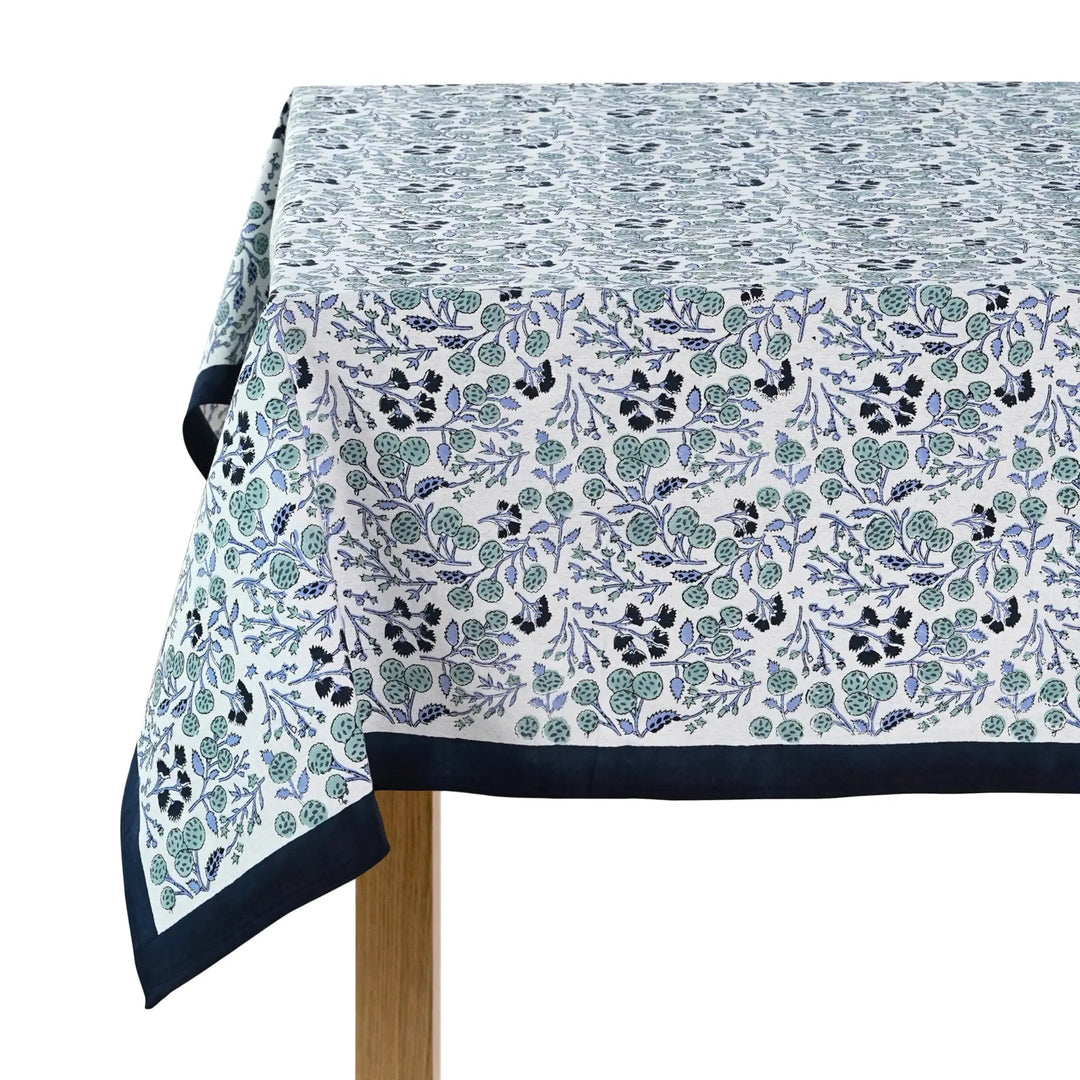 Tablecloth with floral pattern and navy border on a white background