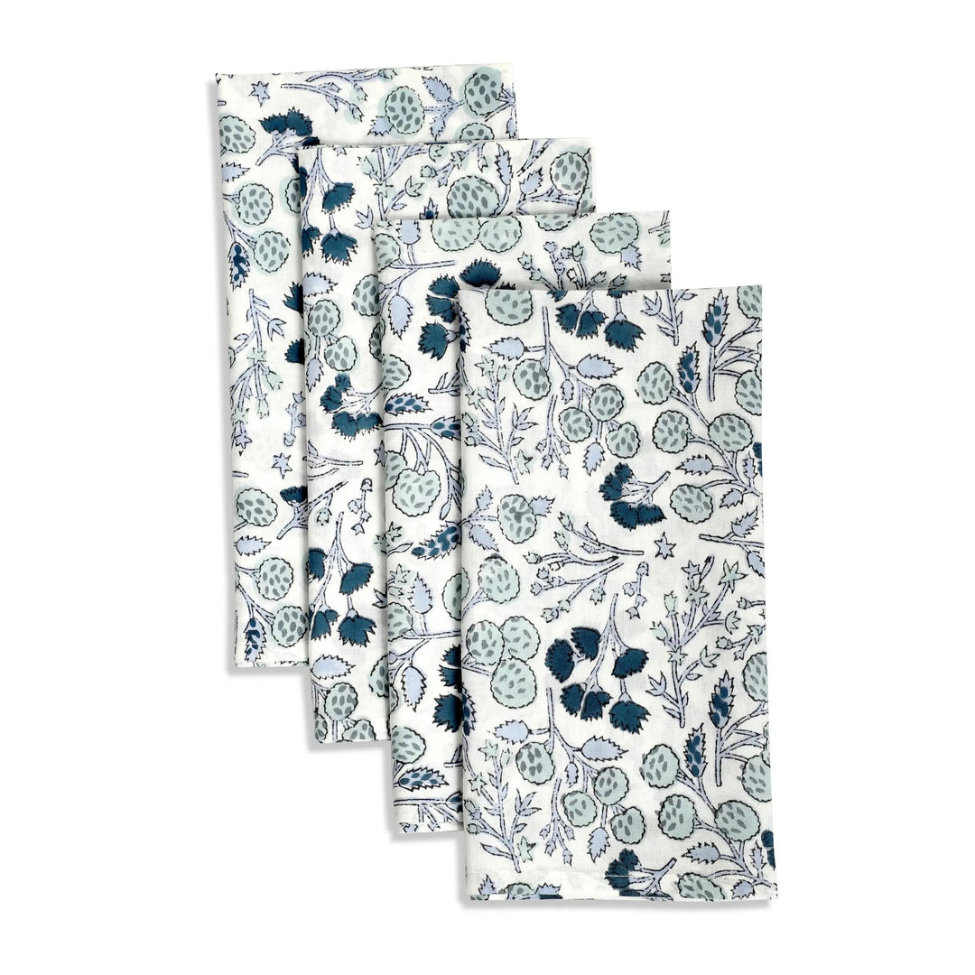 Set of four floral-patterned towels on a white background
