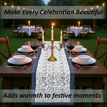 Dining table set for a celebration with candles and a decorative table runner.