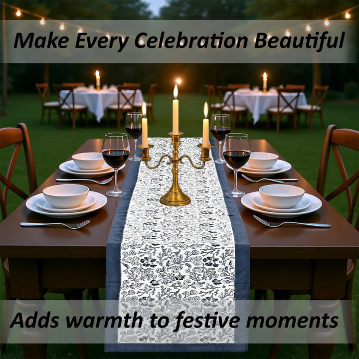 Dining table set for a celebration with candles and a decorative table runner.