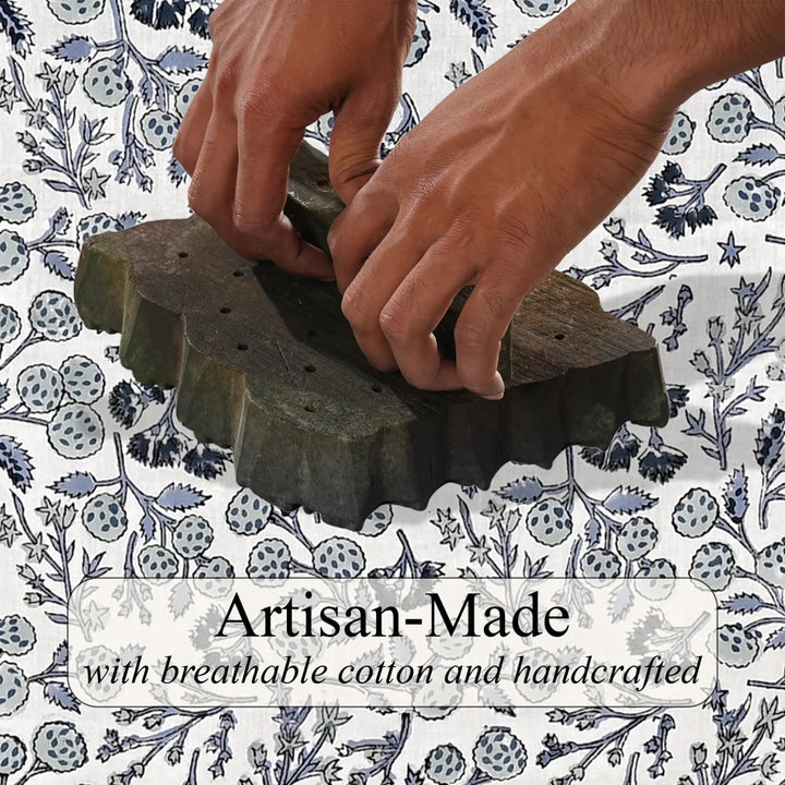 Hands using a wooden tool on fabric with &